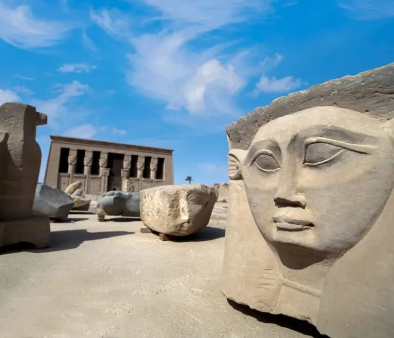 the Dendera Temple of Hathor, located in Egypt. The temple is dedicated to the goddess Hathor, who was associated with beauty, love, and music. The massive face carved into the rock face in front of the temple is believed to represent Hathor.